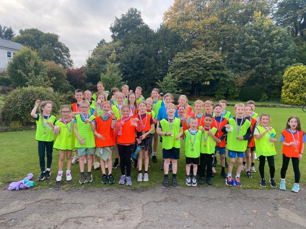 Group photo of junior runners wearing their medals